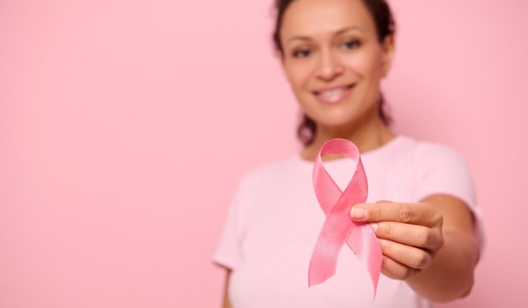 Image d'une femme qui tient un ruban rose au bout des doigts